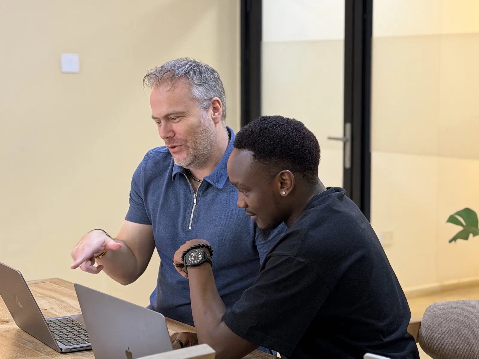 A Data XL colleague talking a teammate through work on screen