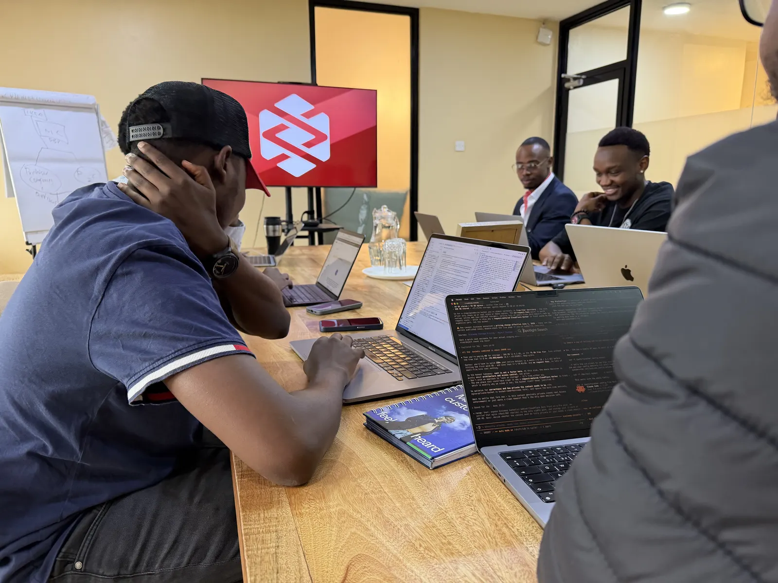 Data XL engineers working together around the table in the Nairobi office